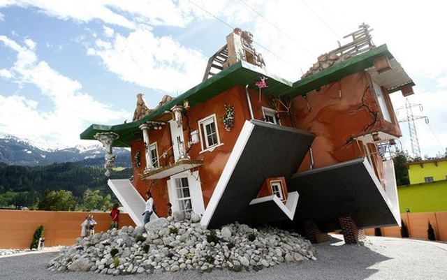 People walk out of a house, which was built upside down by Polish architects Glowacki and Rozanski, in the western Austrian village of Terfens
