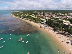 Vista aérea da Praia do Forte na Bahia, mostrando o litoral, hotéis e área urbana